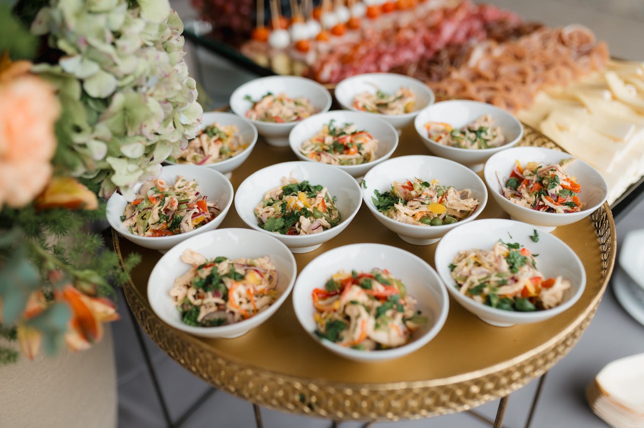 A buffet table with various delicious appetizers served in small bowls, perfect for events.